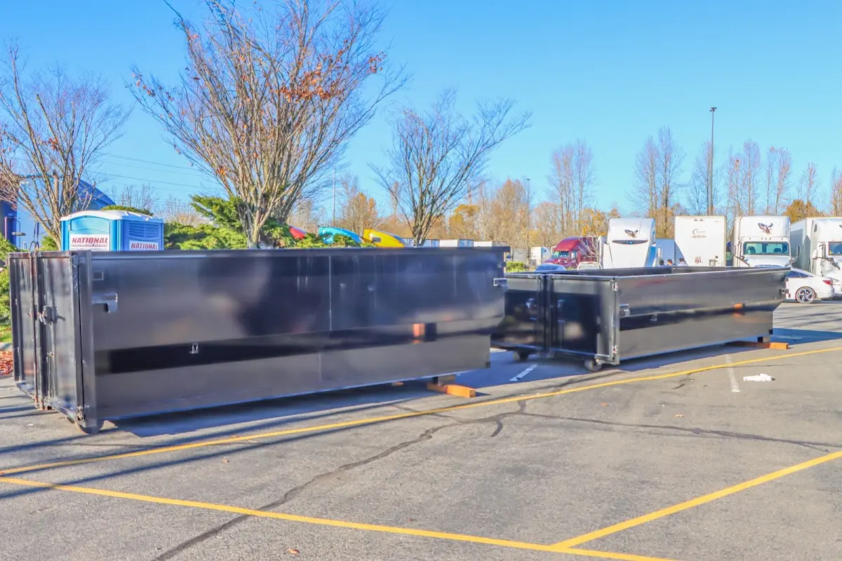 Professional dumpster rental service with roll-off container on residential driveway in Greensboro